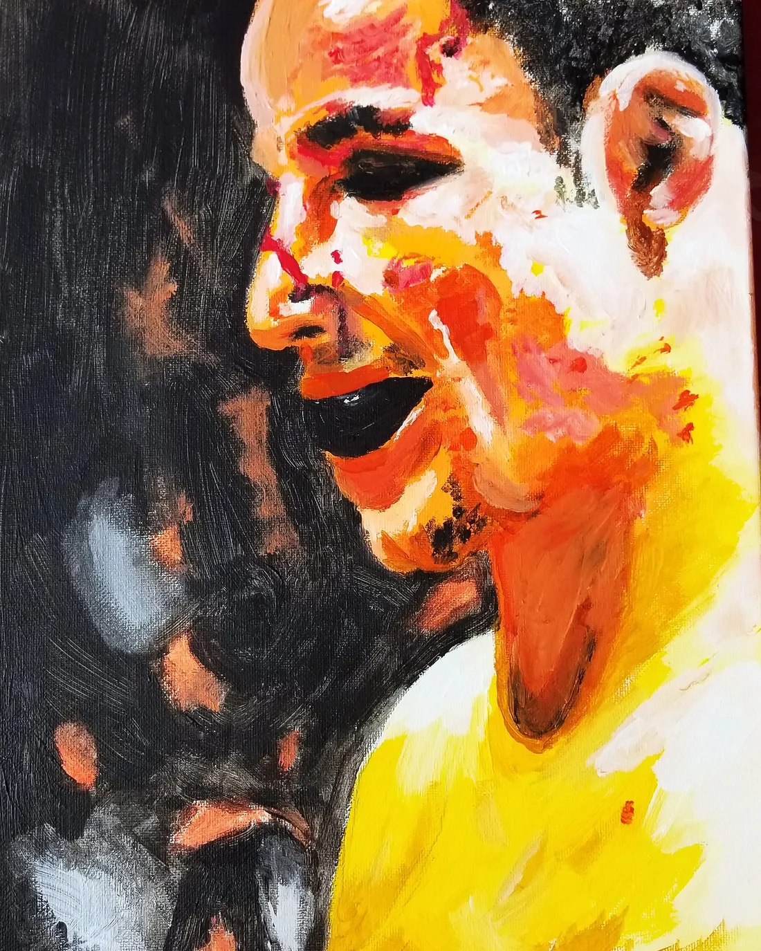 an abstract expressionist face in orange, yellow, and black