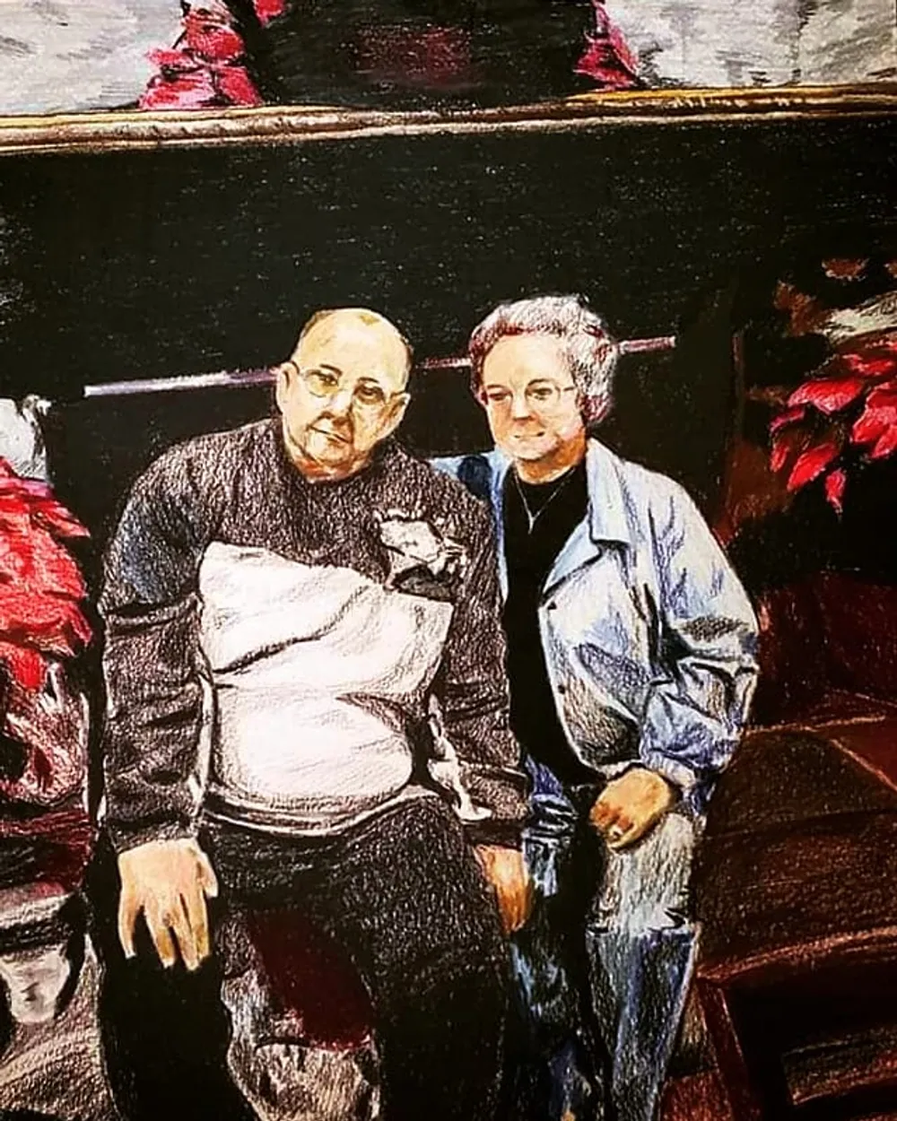two men seated together in front of Christmas poinsettias
