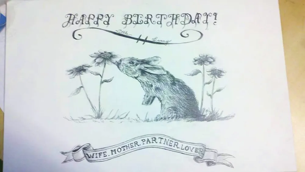 a rabbit sniffing coneflowers, with a birthday message